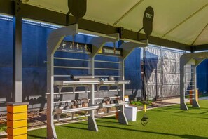 An indoor training facility with a TRX station, kettlebells, and benches. - Kiahuna 150 – Fully Remodeled, A/C, Near Beach (Koloa)