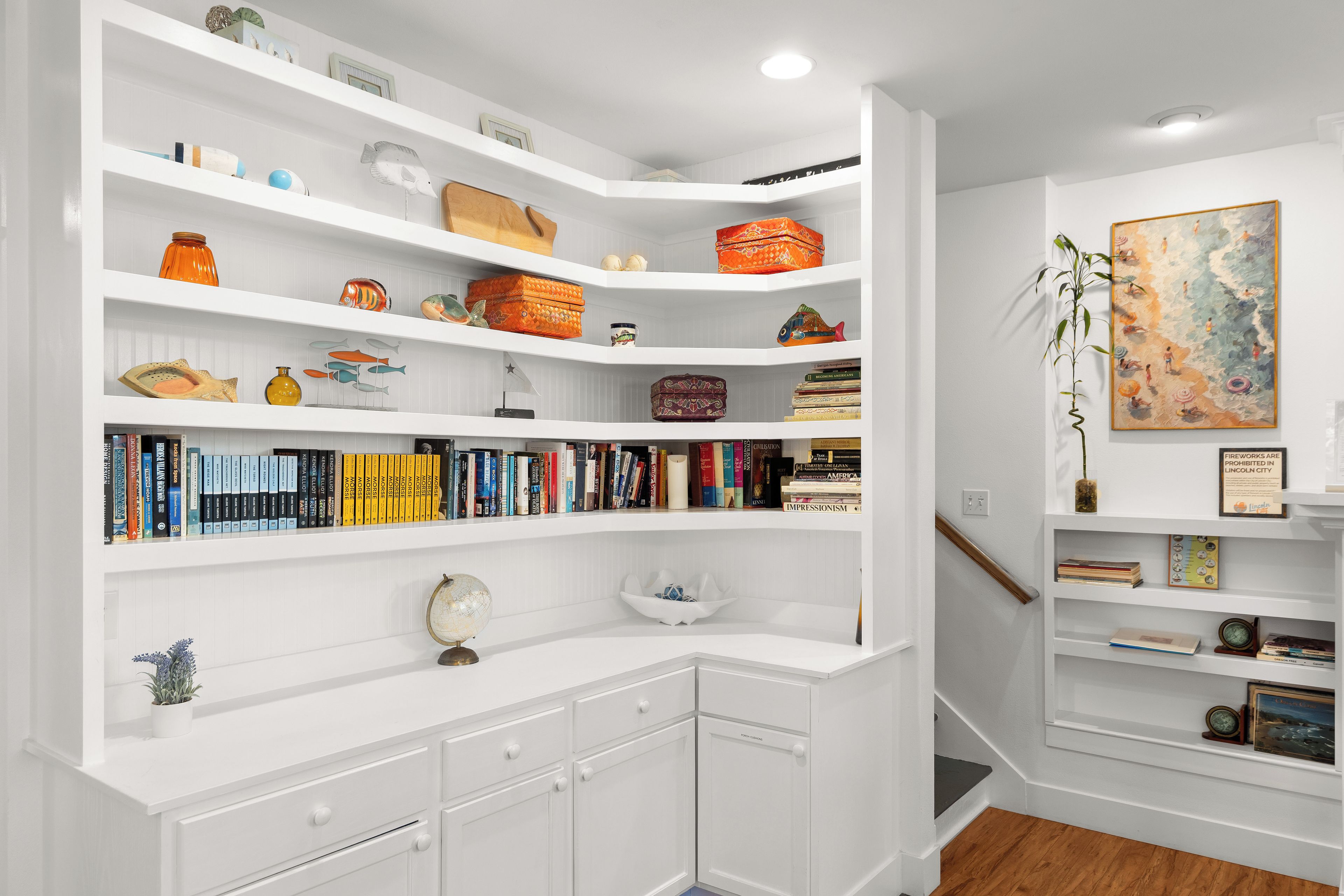 A well-organized bookshelf with various decorative items and books.