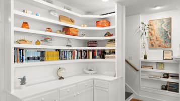 A well-organized bookshelf with various decorative items and books.