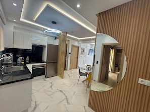 A modern kitchen with a built-in oven, a refrigerator, and a sink. - New Luxury 3-Bedroom Apartment (Casablanca)