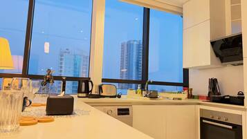 A modern kitchen with a large window, a Bosch oven, a coffee maker, and a toaster.