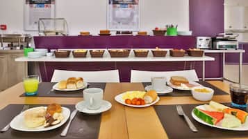 A breakfast buffet with various food items and beverages.