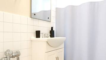 Shower, hair dryer, towels, shampoo