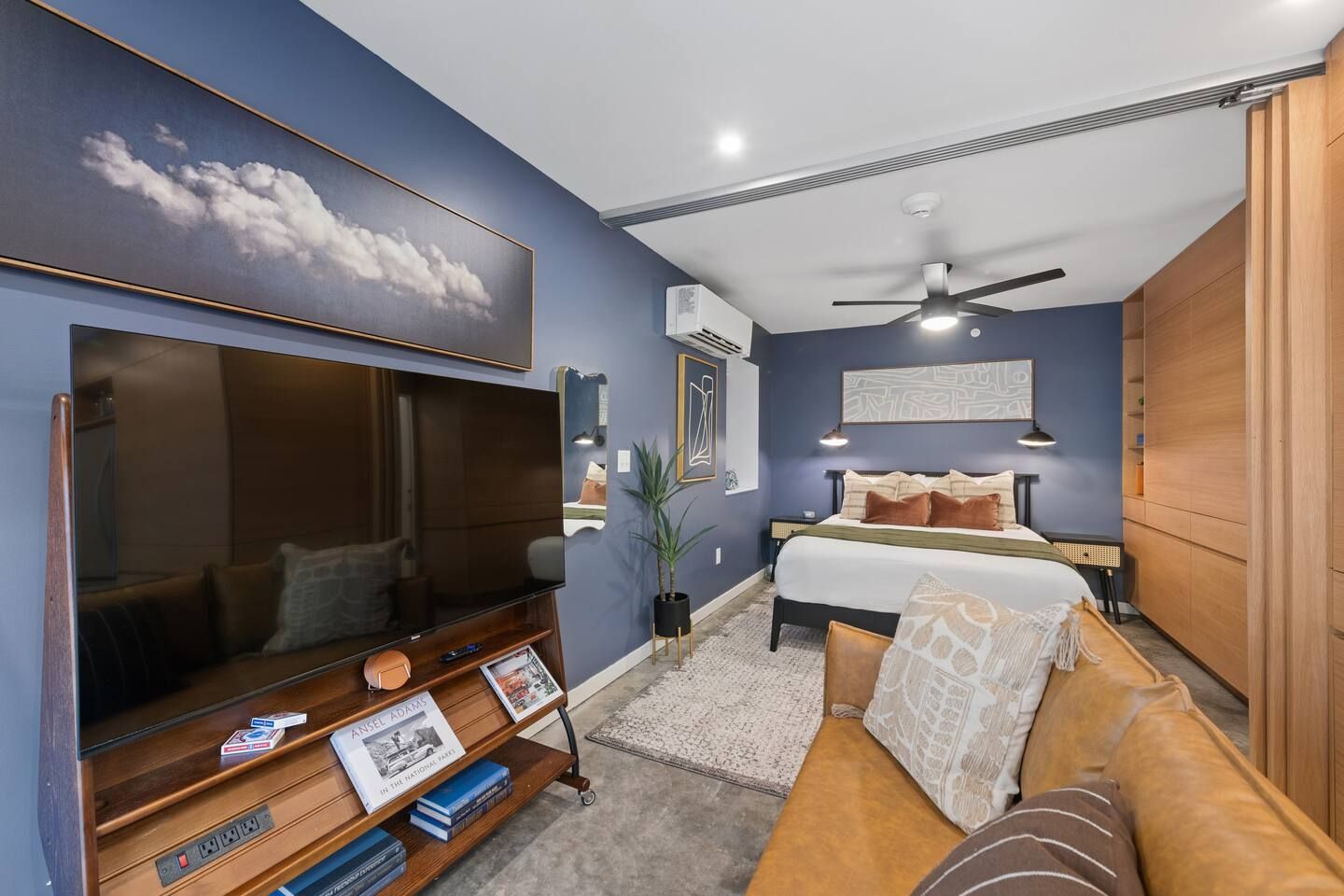 A bedroom with a bed, bedside table, and a TV.