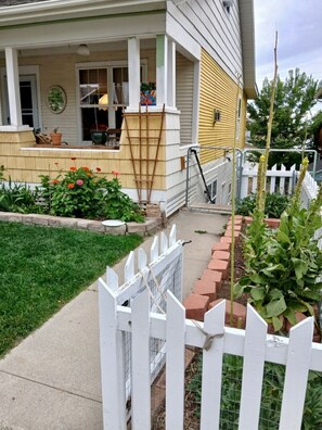 A residential house with a front porch, a small garden, and a white picket fence. - The Kimball St Hideaway - Private & Peaceful (Casper)