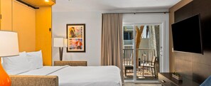 A hotel room with a bed, a TV, a painting, and a balcony with a chair. - F1 LAS VEGAS 2026 - 2BR RESORT FOR 6 - NOV 19-22 - 392/NIGHT (Las Vegas)