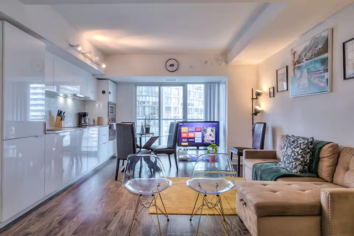 Un espacio de estar moderno con cocina, comedor y zona de descanso.