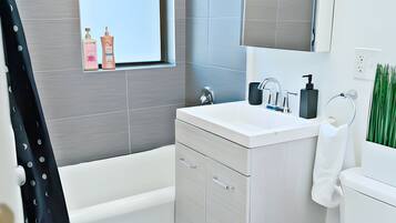 Shower, hair dryer, towels, shampoo