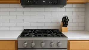 A kitchen with a stainless steel stove, oven, and a set of knives in a wooden holder. - 1BR Fully Equipped & Central (Chicago)