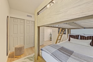 A room with a bunk bed, a door, a small stool, and a plant. - Scottsdale Desert Retreat | Private Hot Tub (Scottsdale)