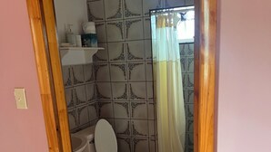 A bathroom with a toilet, a sink, and a shower area. - perfect for family. Angler and nature guides (Queens highway)