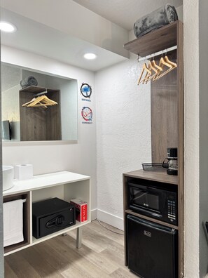 A modern bathroom with a white vanity, a mirror, a towel rack, a coffee maker, a microwave, and a refrigerator. - Family-Friendly Room, 2 Queens, Pool, Near Disney (Kissimmee)
