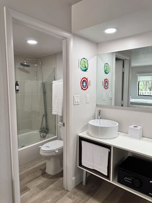 A modern bathroom with a glass-enclosed shower, a white toilet, a white sink, and a mirror with decorative stickers. - Family-Friendly Room, 2 Queens, Pool, Near Disney (Kissimmee)