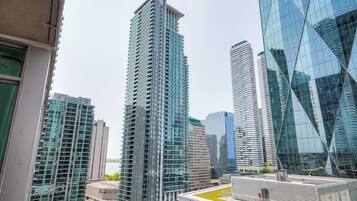 A high-rise building with a modern glass facade, surrounded by other tall buildings.