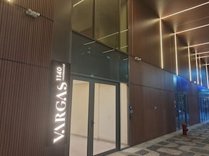 A modern building facade with a prominent sign for 'VARGAS 1140 residential' and a fire hydrant on the ground. - Vrbo Property (Rio de Janeiro)