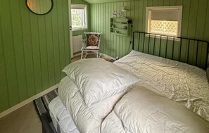 A room with a bed, a chair, a radiator, and a window with blinds. - Gorgeous home in Juelsminde with WiFi (Juelsminde)