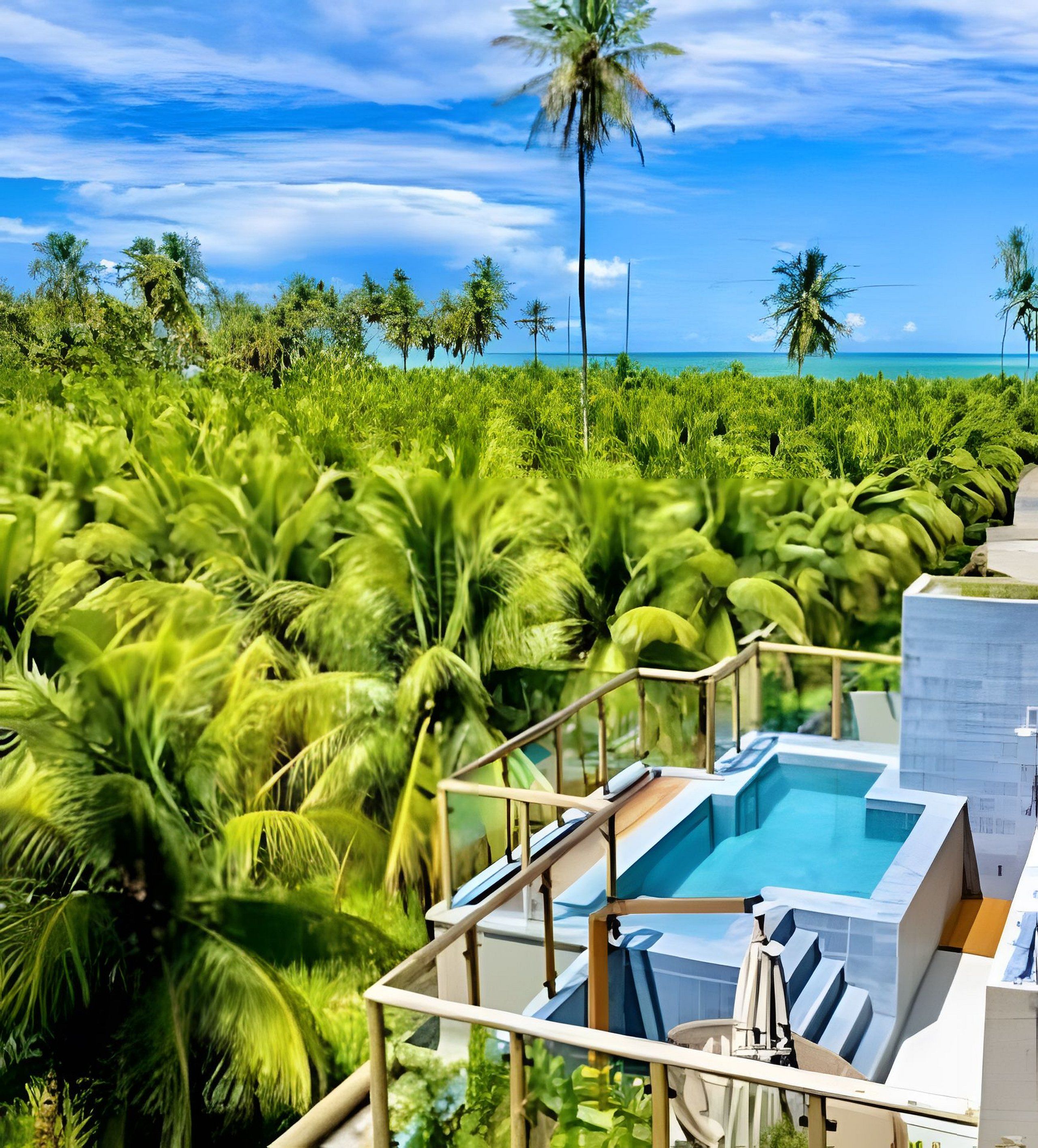 Zona de piscina con vista al océano y palmeras.