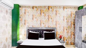 A modern bedroom with a large bed, a nightstand, a green textured wall, and a patterned wallpaper.