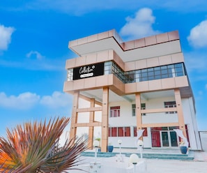 A modern building with a sign that reads 'Collection' and 'Company Serviced.' - Classic Grand Jvi Resort & Marriage Lawn (Faizabad)