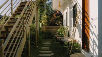 A staircase leading to a house with a garden path.