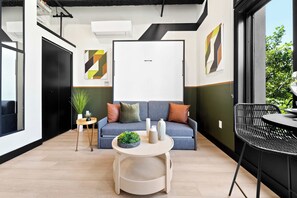 A modern interior with a sofa, a round table, and a chair. - Petco Park Nearby Walk to Gaslamp, Dine & Explore (San Diego)