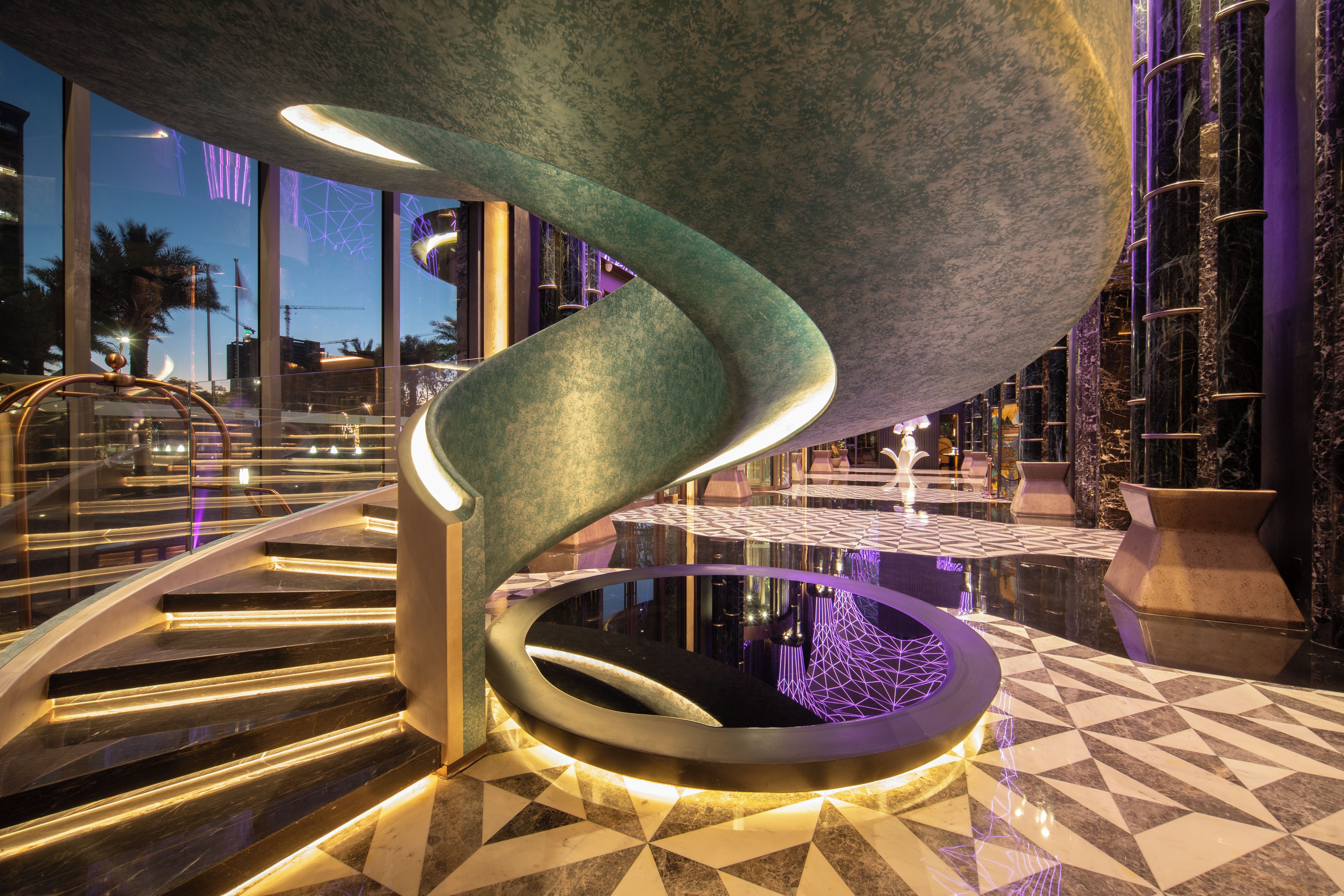 A modern interior with a spiral staircase, a reflective pool, and a geometric floor pattern.