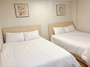Two single beds with white bedding and headboards, a plain wall, and two framed botanical prints. - The Shim Hotel Busan Station (Busan)