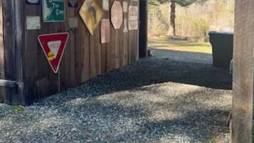 A wooden structure with various signs, including a US 321 S sign, a directional sign, and a yield sign.