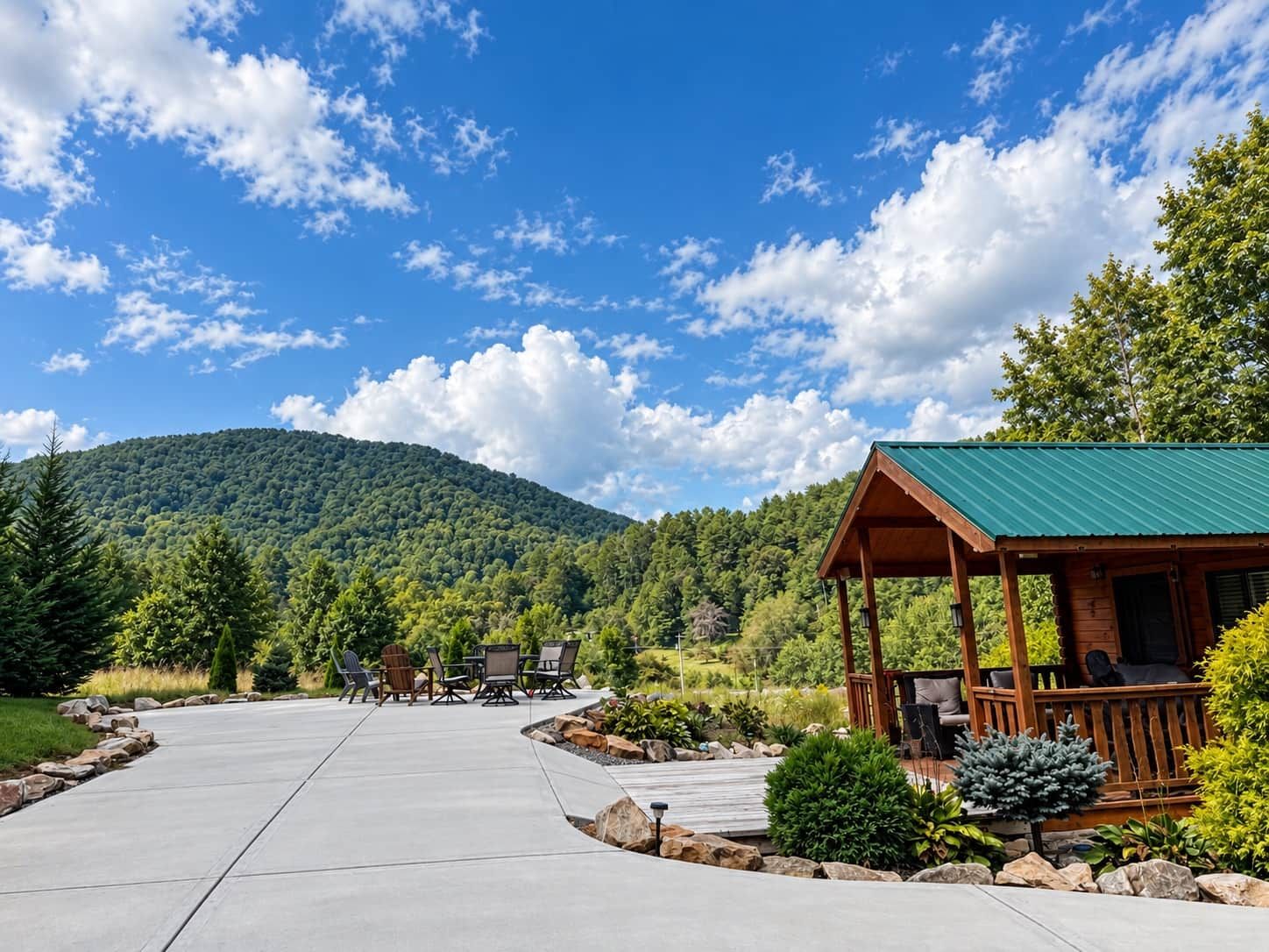 A lodge with a covered porch, a concrete patio, and a view of a forested mountain.