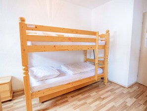 A bunk bed in a room with a wooden floor and white walls. - Apartment mountain view - 4 guests (Villarodin-Bourget)