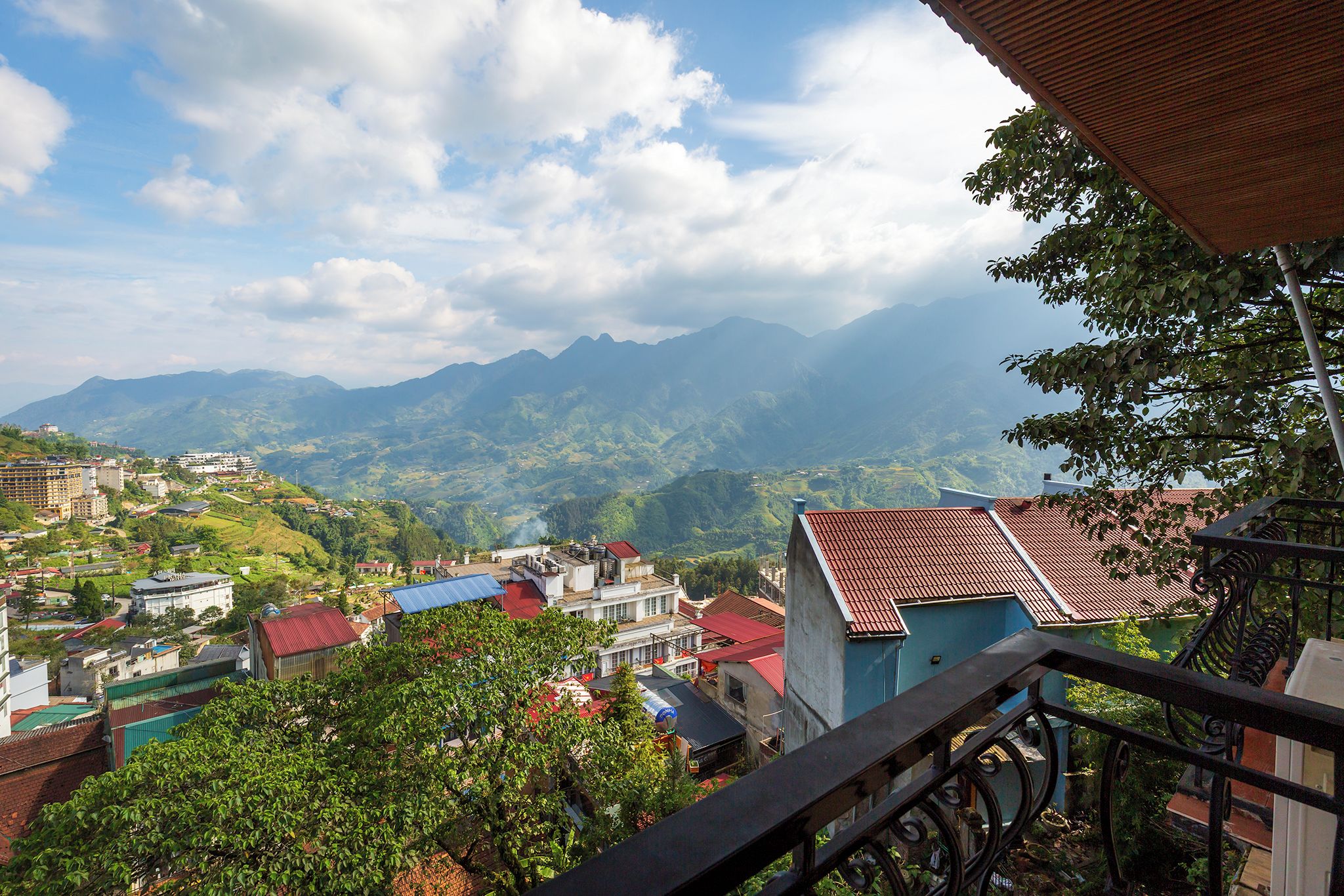 A mountainous landscape with buildings and a view of the valley below.
