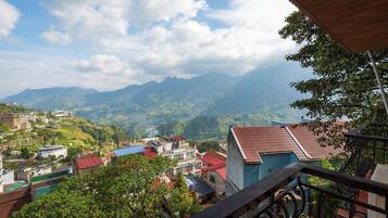 A mountainous landscape with buildings and a view of the valley below.