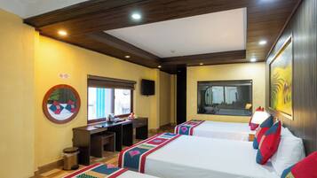 A hotel room with two beds, a desk, a trash can, and a large window.