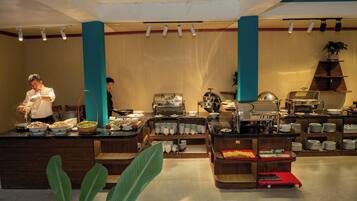 A buffet area with various food stations, a buffet counter, and a coffee station.