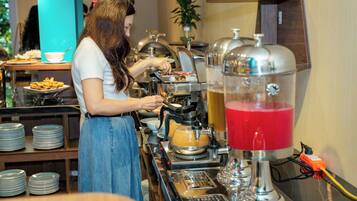 A buffet setup with a beverage dispenser and food items.