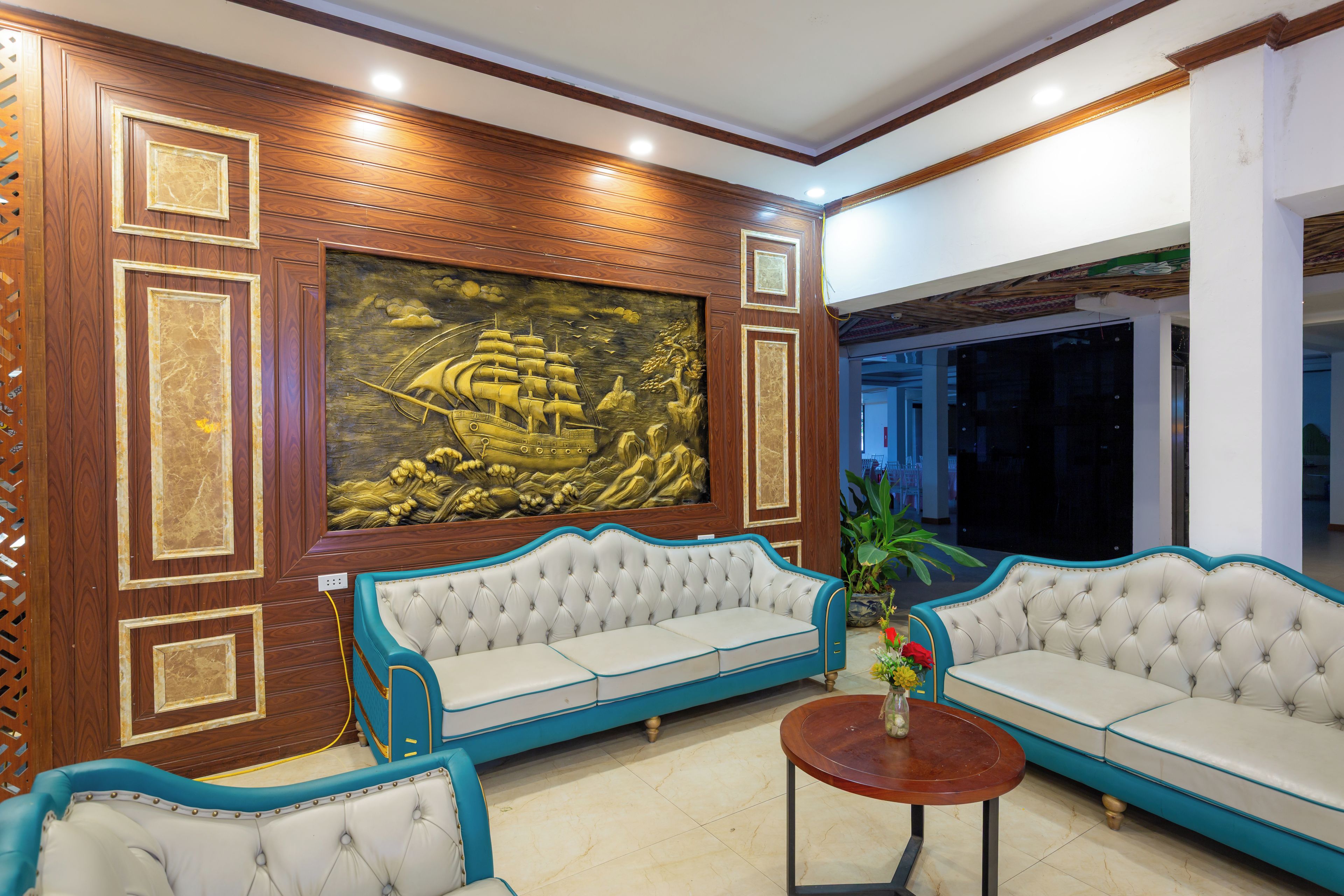A room with a large mural, two sofas, and a coffee table.