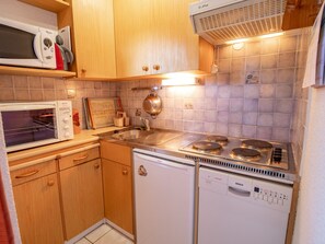 A compact kitchen with a microwave, stove, and dishwasher. - Apartment with balcony, mountain view - 6 guests (Villarodin-Bourget)