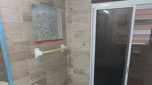 A bathroom with a sink, toilet, and shower area. - Loaded 2-bedroom view condo on the prettiest
beach in Vallarta (Jal.)
