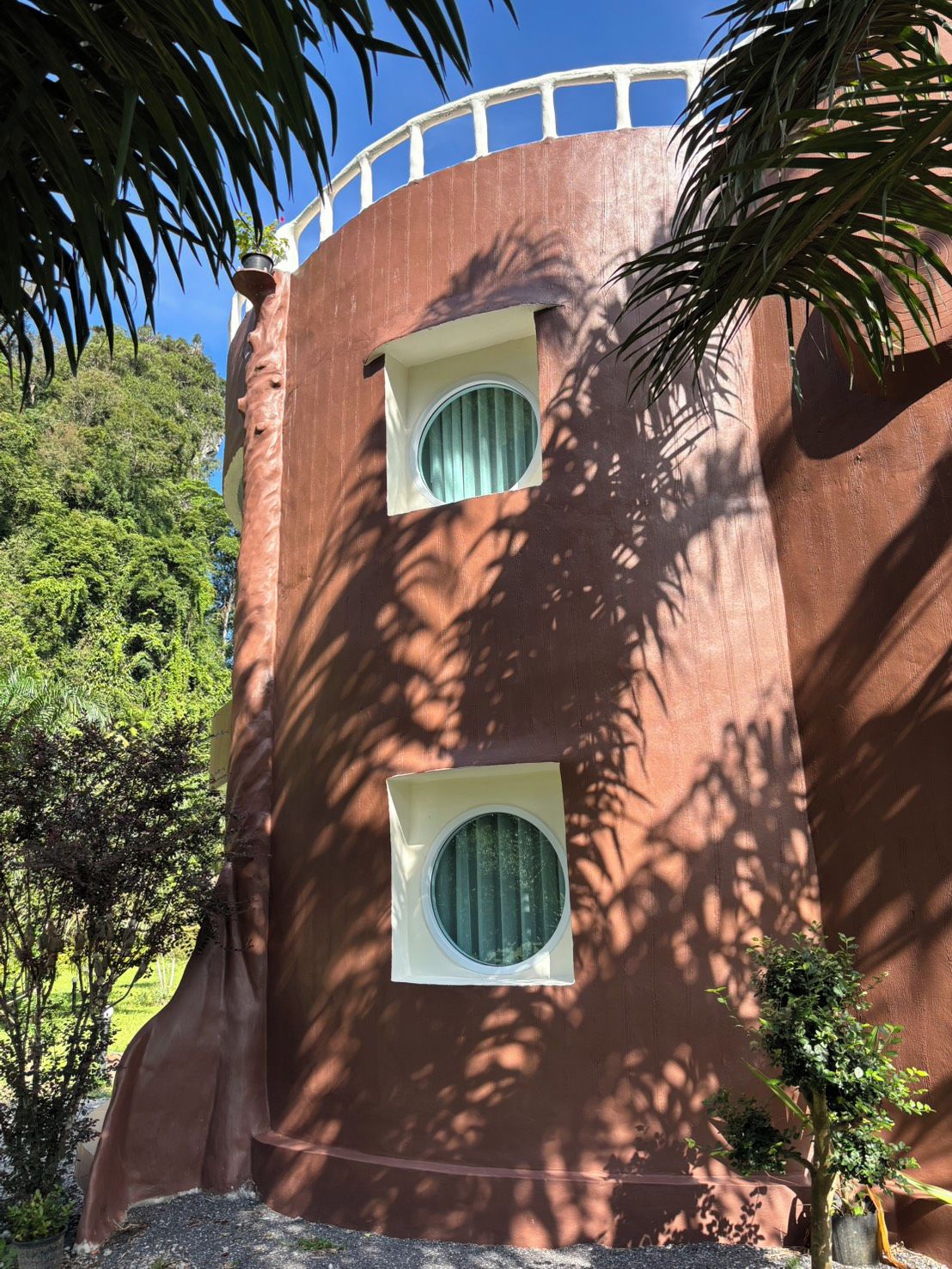 A building with a curved facade and two circular windows.