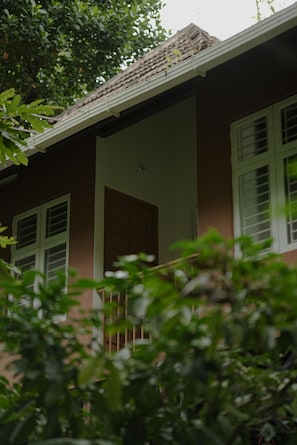 A house with a porch, a door, and windows.