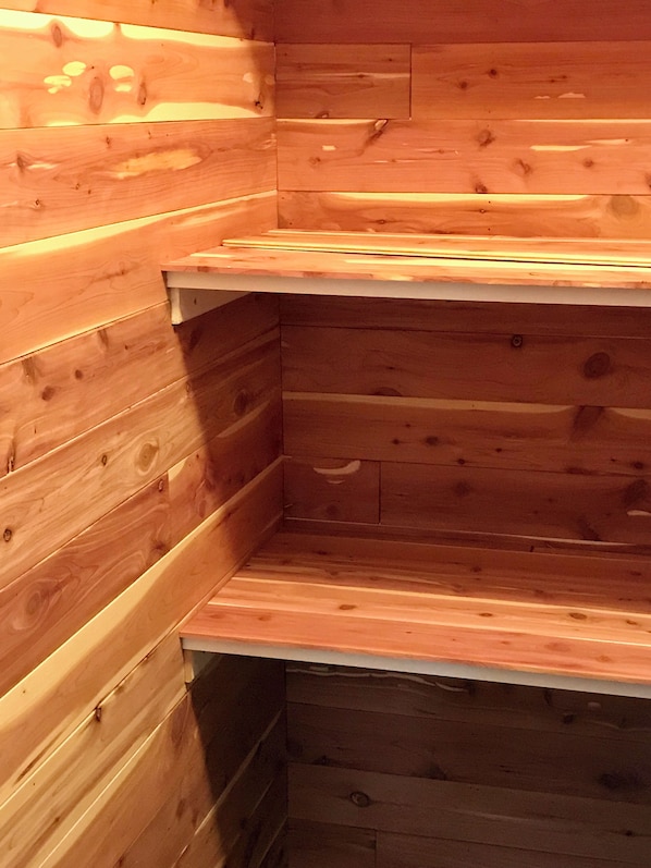 A corner of a wooden cabin with a built-in bench.