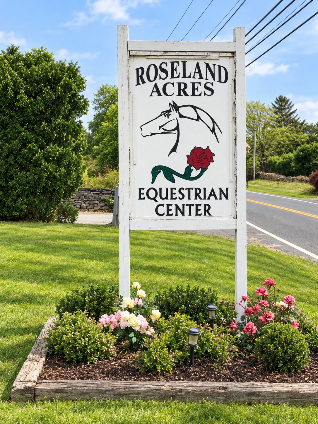 A sign for Roseland Acres Equestrian Center with a horse and rose graphic.