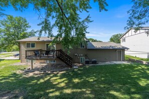 A two-story house with a deck, a covered outdoor seating area, and a well-maintained lawn. - Pioneer Place | King Bed | Deck | 3-Min to Avera (Sioux Falls)