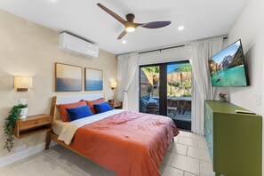 A bedroom with a bed, a ceiling fan, a TV, and a view of the outdoors through a sliding door. - SAN DIEGO SPA VILLA - Cozy Yard, Firepit, Rec Room (San Diego)