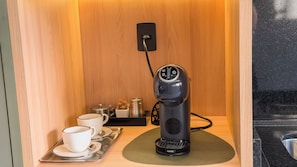 A compact room with a coffee machine, a tray with cups and a spoon, and a small table with a kettle and salt and pepper shakers. - Kaya Parque Sinop (Sinop)