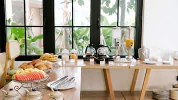A breakfast buffet with various food items and utensils.