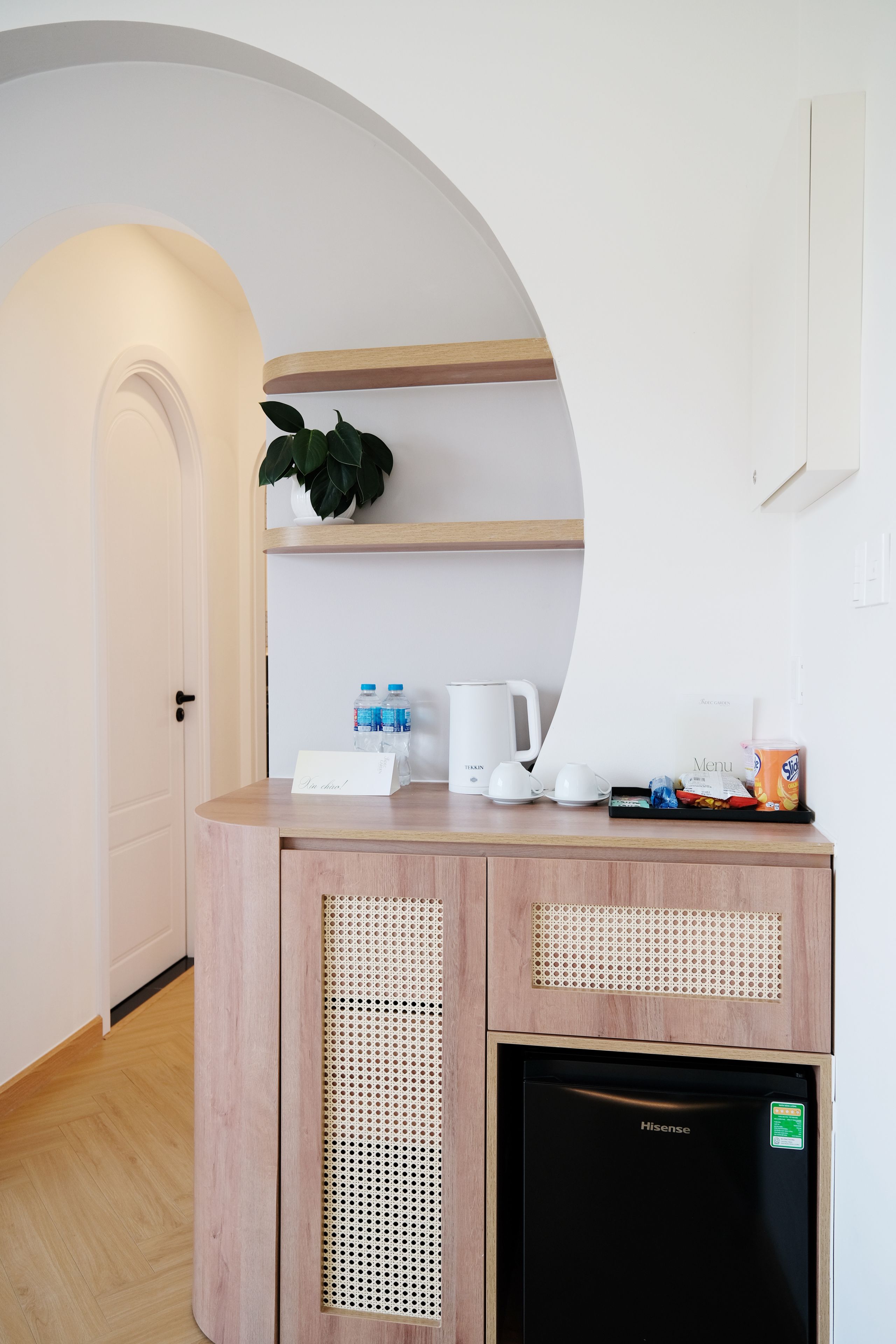 A kitchenette with a coffee maker, water bottles, and a tea kettle.