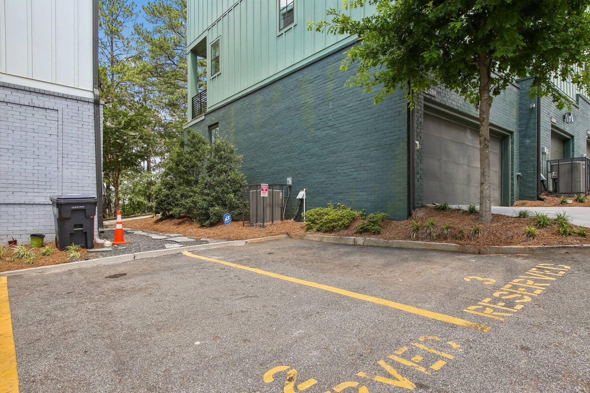 A parking area with yellow lines and a sign indicating a reserved space.