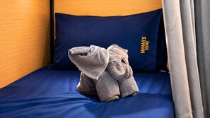 Una cama individual con un colchón azul y una almohada azul oscuro.