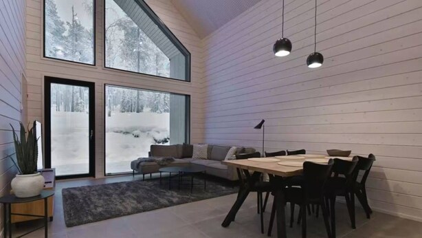 A modern interior with a dining area, a sofa, and large windows. - Villa QUU C,  Premium 4BD Villa with Sauna (Kolari)